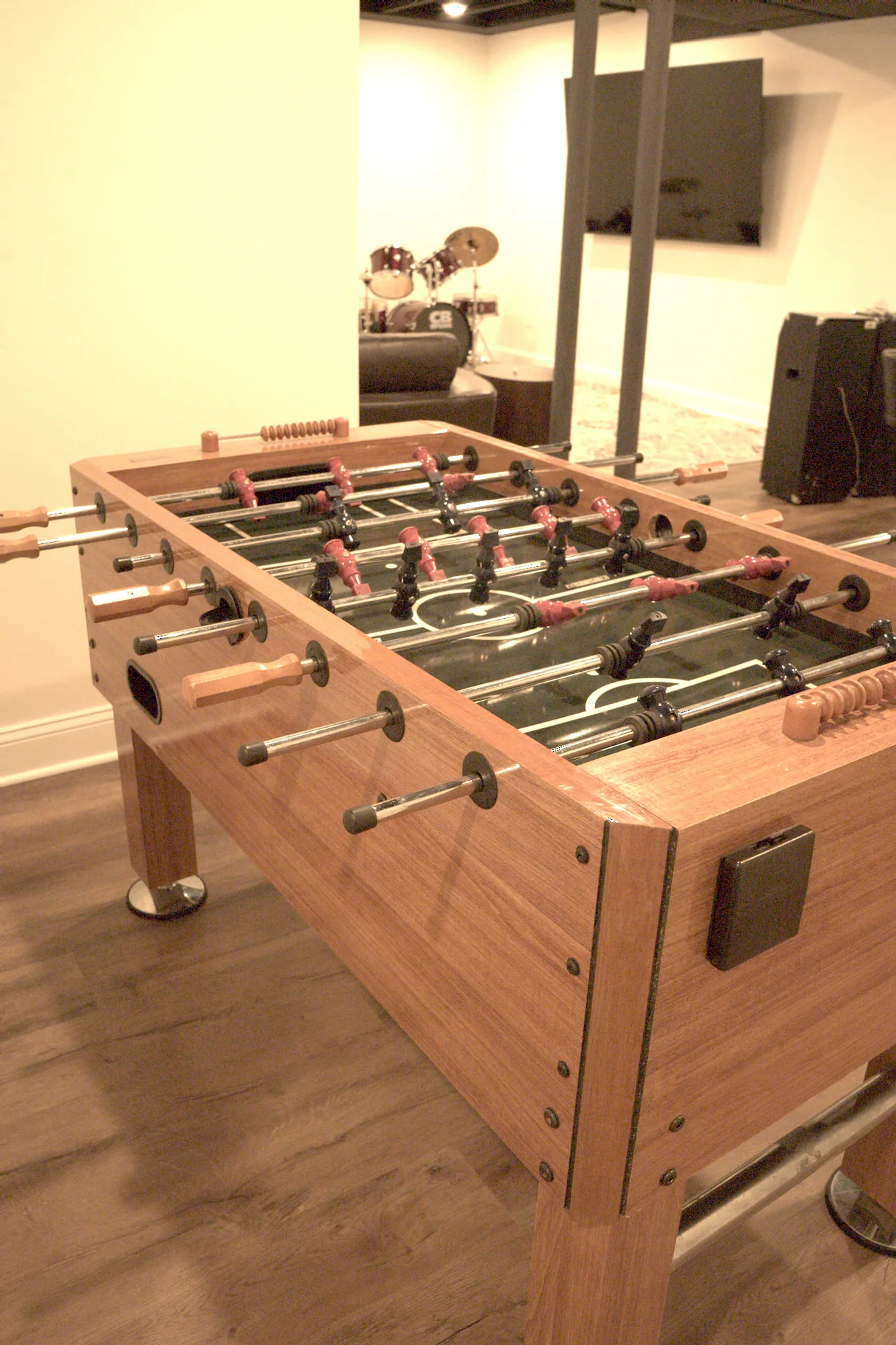 Basement game room with foosball table and exposed black ceiling