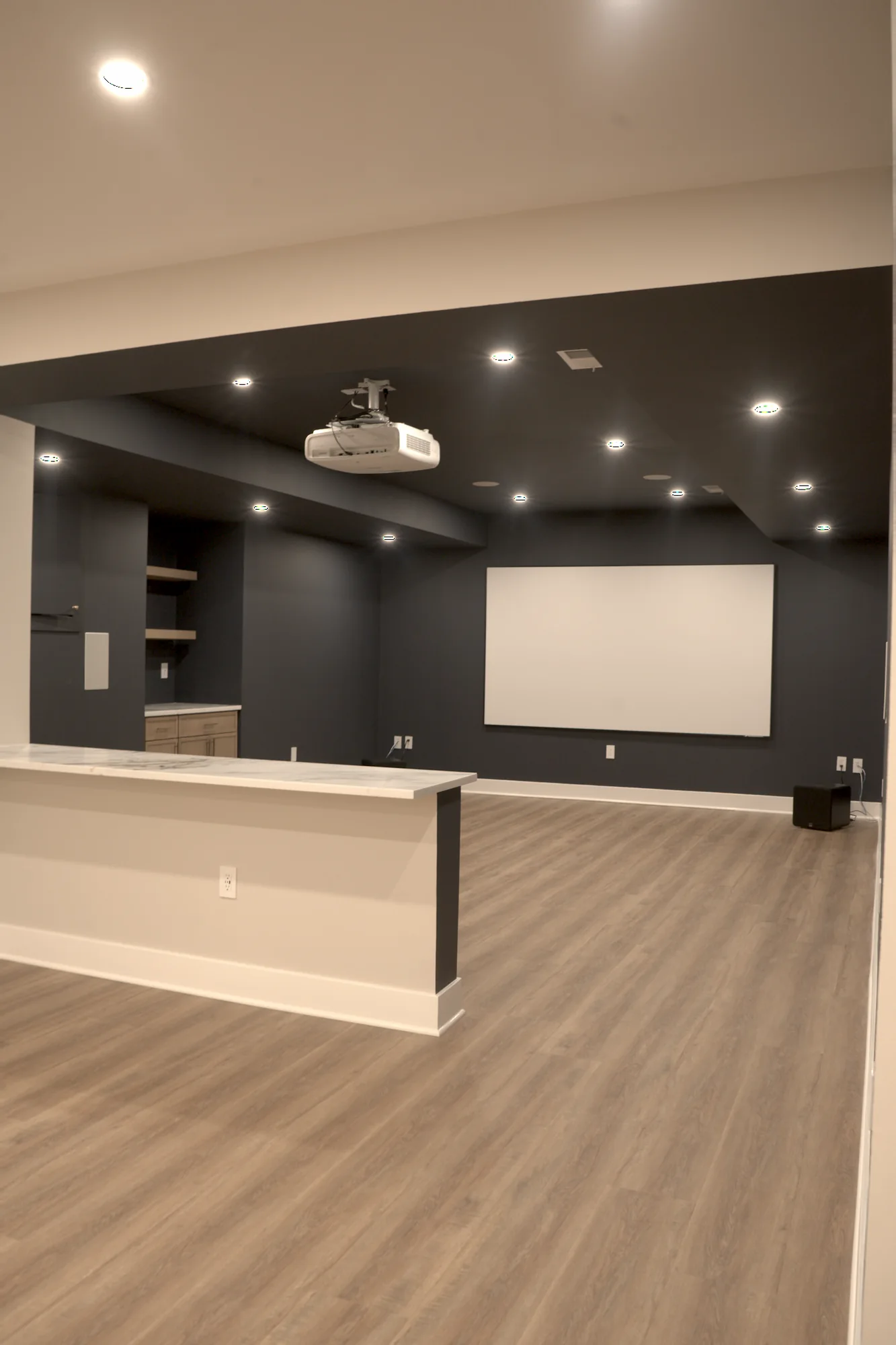 Finished basement home theater with projector screen
